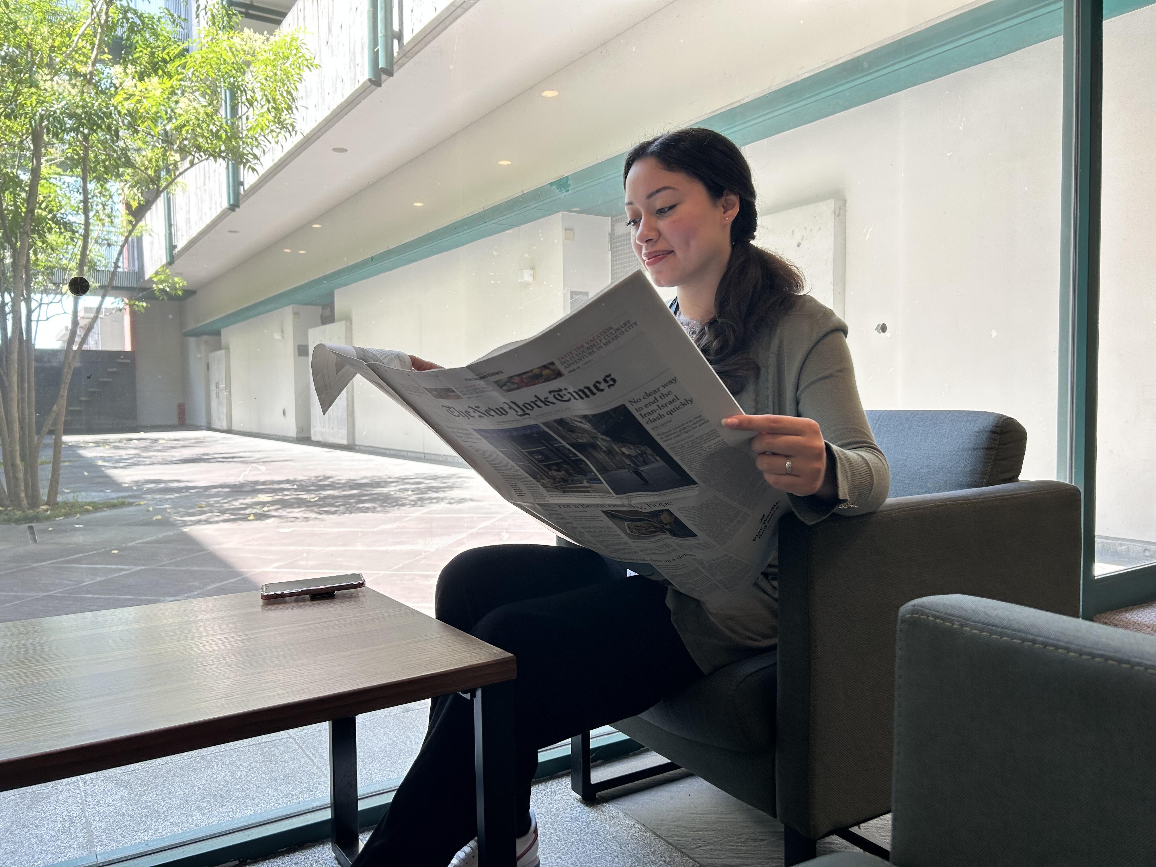 Reading the newspaper at i-house.JPG